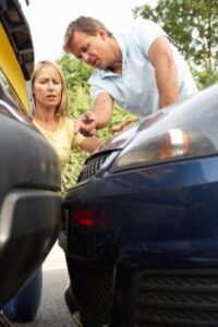 Man And Woman Having Argument After Traffic Accident